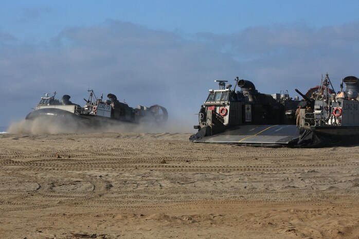 A U.S. Navy pilot positions Landing Craft Air Cushion 73 next to Landing Craft Air Cushion 48 during amphibious assault training on Camp Pendleton, Calif., August 2, 2016. The LCAC carries cargo, vehicles like high mobility multi-purpose wheeled vehicles and M1A1 Abrams tanks, and personnel for ship to shore movements. (U.S. Marine Corps photo by Lance Cpl. Shellie Hall)