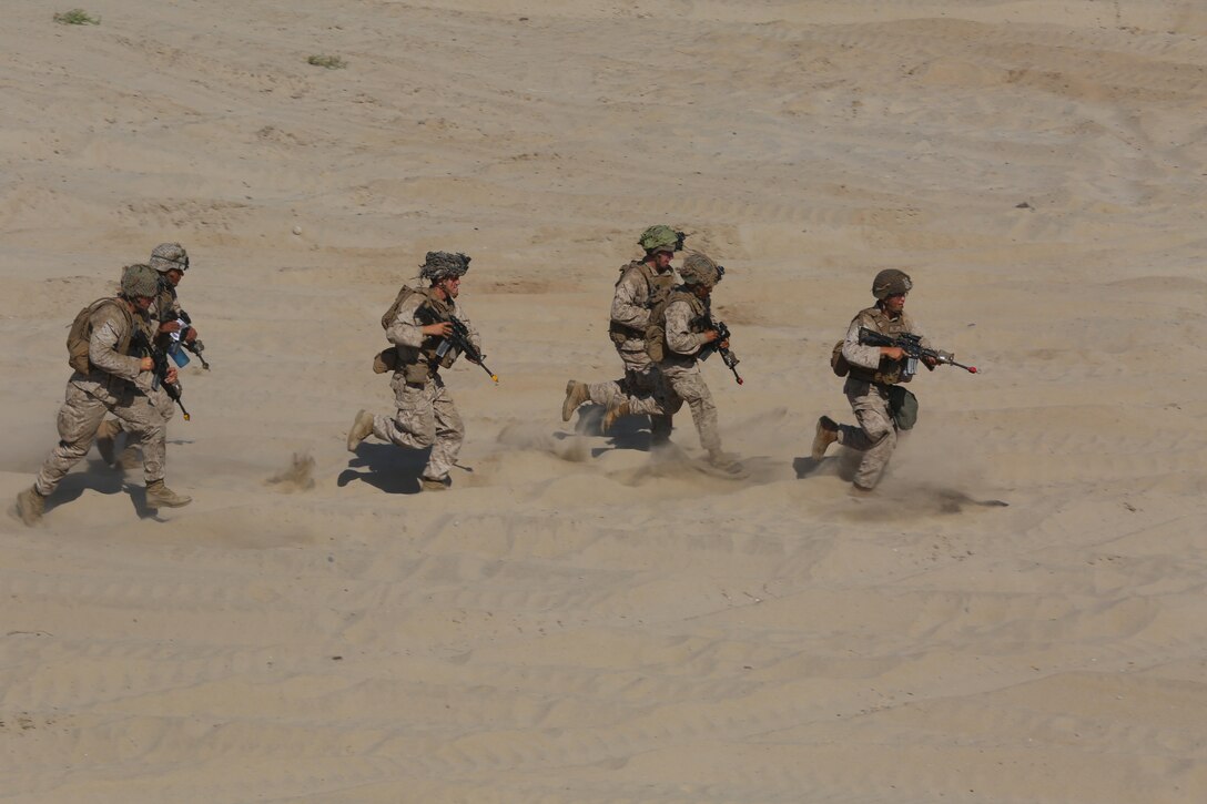 Marines with 3rd Battalion, 1st Marine Regiment, 1st Marine Division move quickly to provide security during a Marine Corps Combat Readiness Evaluation on Camp Pendleton, Calif., August 2, 2016. During a MCCRE, Marines perform various events to determine the combat readiness of the unit. (U.S. Marine Corps photo by Lance Cpl. Shellie Hall)