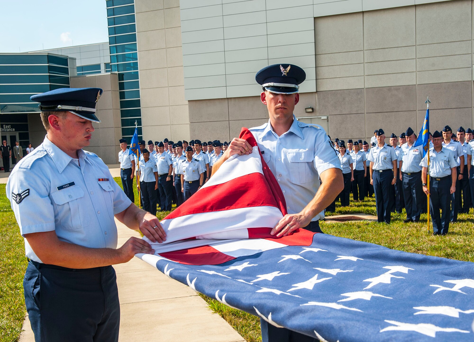 Airmen from the National Air and Space Intelligence Center participate in a retreat ceremony at Wright-Patterson Air Force Base, Ohio, Aug. 1, 2016. Retreat ceremonies serve a twofold purpose to signal the end of the official duty day and to pay respect to our nation's flag. Because the time for the end of the duty day varies, the commander designates the specific time for the retreat ceremony. (U.S. Air force photo/Tech. Sgt. Eunique P. Thomas)