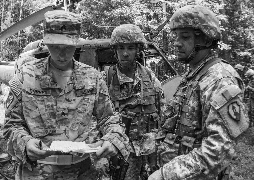 Sgt. Destinee Surber, left, an observer/controller with the 111th Quartermaster Company (Mortuary Affairs) from Fort Lee, Va., checks the paperwork of Sgt. Hector Torres, center, and Staff Sgt. William Rivera, both with the U.S. Army Reserve's 246th Quartermaster Company (Mortuary Affairs), Mayaguez, Puerto Rico, during a search and recovery mission during Mortuary Affairs Exercise 16-02, July 21, at Fort Pickett, Va. MAX 16-02 included all six U.S. Army Reserve Mortuary Affairs units performing search and recovery missions and operating Mortuary Affairs Collection Points and a Theater Mortuary Evacuation Point. The units were evaluated by active-duty mortuary affairs personnel from nearby Fort Lee, Va. (U.S. Army photo by Timothy L. Hale)(Released)