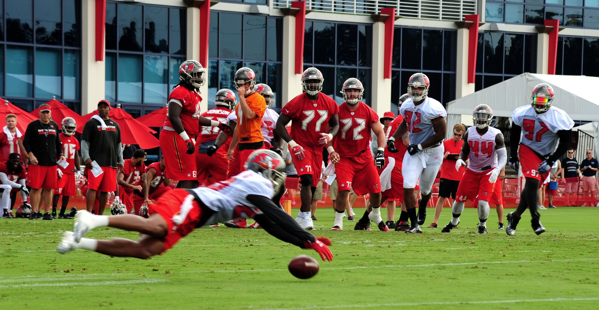 Players at the 2016 Tampa Bay Buccaneers Training camp rush towards a player after he dives for a catch July 29, 2016 at the Raymond James Stadium in Tampa, Fla. The players spent most of their morning running drills such as passing plays and defensive line drills. (U.S Air Force photo by Airman 1st Class Rito Smith) 