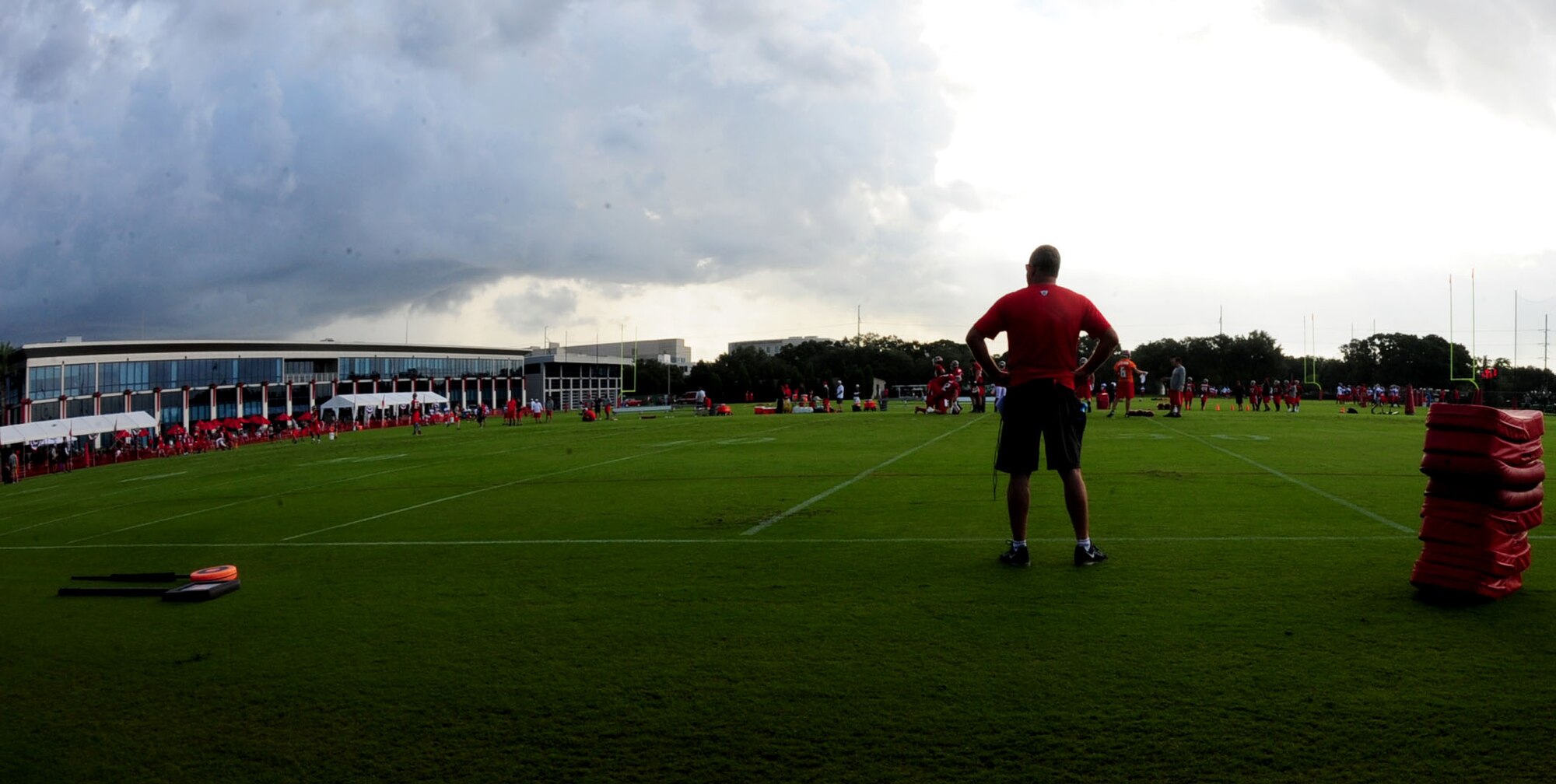 A coach with the Tampa Bay Buccaneers stands on the field getting ready for the next drill during their second day of training camp July 29, 2016 at the Raymond James Stadium in Tampa, Fla. The coaches had different drills planned out in alternating intervals to allow a constant flow of hard work and motivation from the players. (U.S Air Force photo by Airman 1st Class Rito Smith) 