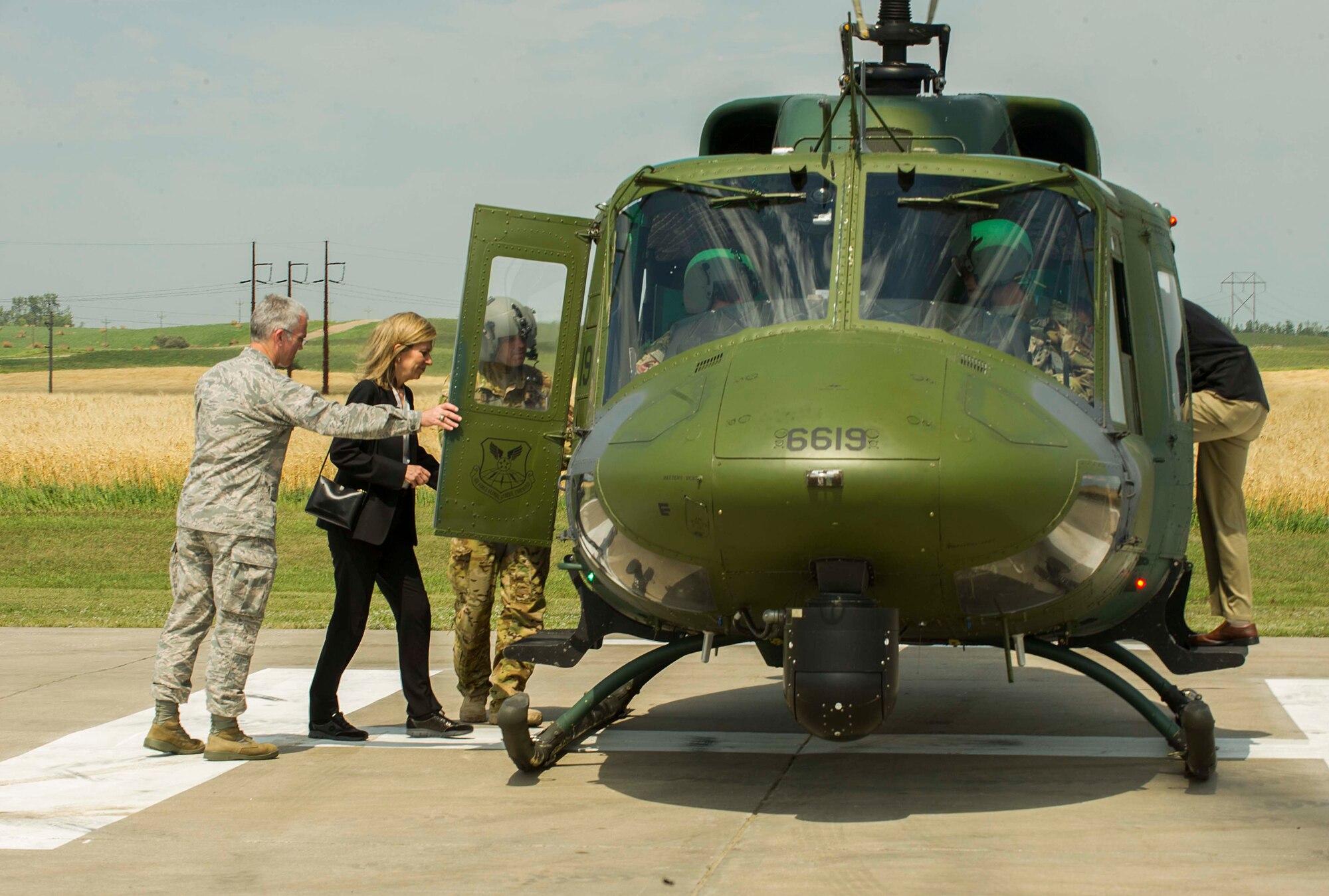Dr. Elizabeth Sherwood-Randall, deputy secretary of energy, and Gen. Paul Selva, vice chairman of the Joint Chiefs of Staff, enter a UH-1N Huey at C-01 missile alert facility, N.D., Aug. 3, 2016. While travelling in the Huey, Sherwood-Randall and Selva were briefed on the transportation routes to certain missile sites. (U.S. Air Force photo/Senior Airman Apryl Hall)