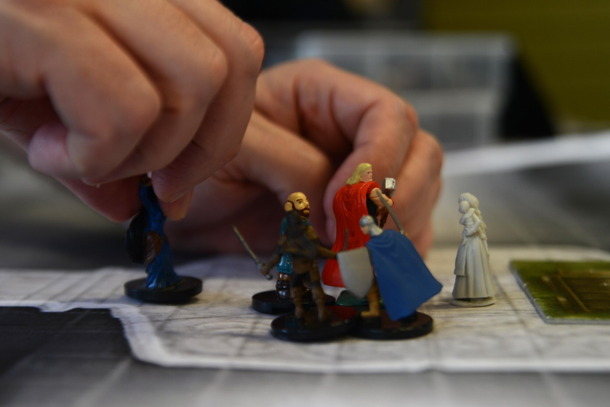 A player moves a figurine during a Pathfinder campaign at the Spenard Road Bosco’s comic book store, Anchorage, Alaska, July 23, 2016. Figurines, models and maps help players and game master alike visualize the scenario. 