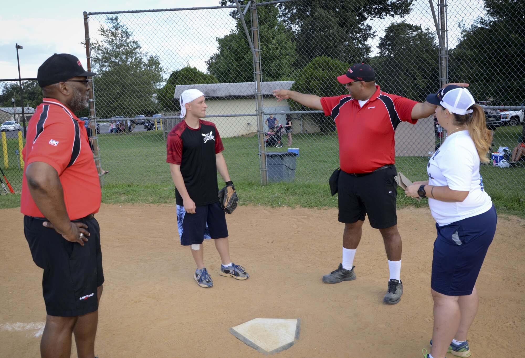 Umpires explain the rules to the coaches before the Division ONE Softball Championship game between the 34th Intelligence Squadron and the Navy Information Operations Command, August 3, 2016 at Fort Meade, Md. Both teams finished the regular season with an 8-4 win/loss record. (U.S. Air Force photo/Staff Sgt. AJ Hyatt)