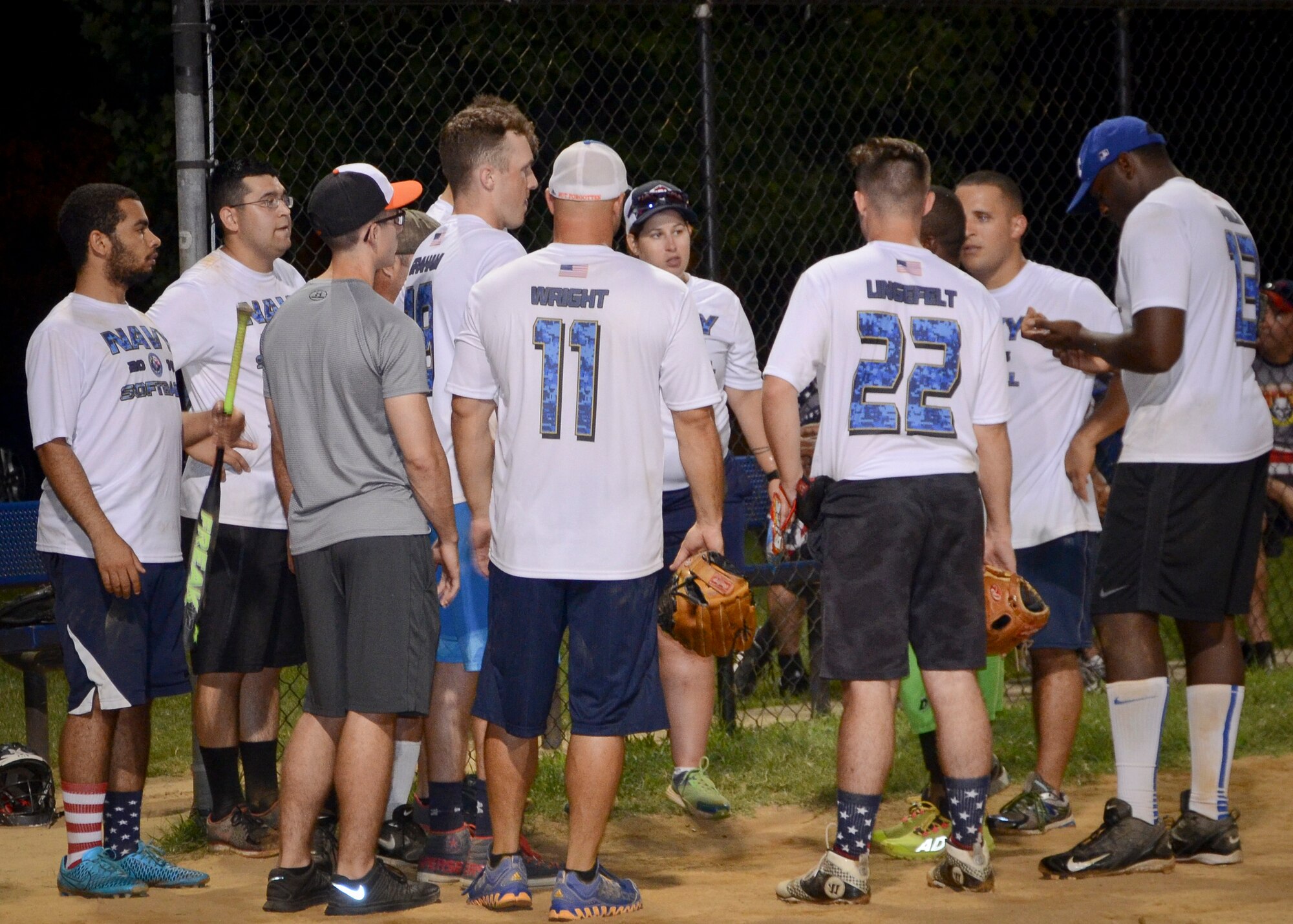 Softball players from the Navy Information Operations Command and the 34th Intelligence Squadron discuss the score with the scorekeeper during the Game 2 Division ONE Intramural Softball Championship game against the 34th Intelligence Squadron, August 3, 2016 at Fort Meade, Md. The 34th IS went on to win the Championship game 31 to 25. (U.S. Air Force photo/Staff Sgt. AJ Hyatt)