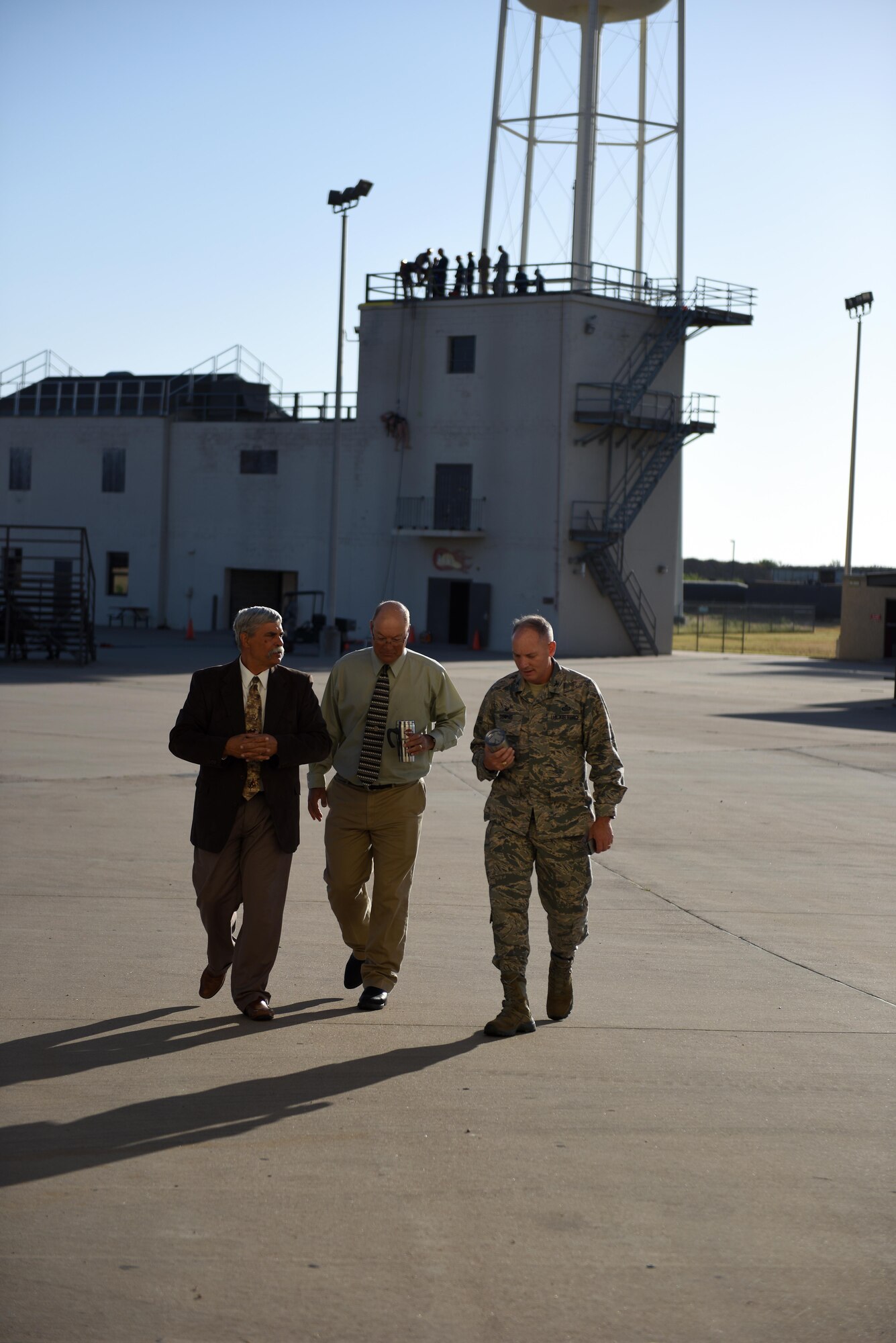 U.S. Air Force Col. Michael Downs, 17th Training Wing Commander, speaks with civilian instructors before the Fire Marshall Training Course kicks off at the Louis F. Garland Department of Defense Fire Academy on Goodfellow Air Force Base, Texas, Aug. 2, 2016. The course trained civil engineer squadron commanders from across the nation so they could earn a Fire Marshall certification. (U.S. Air Force photo by Airman 1st Class Caelynn Ferguson/Released)