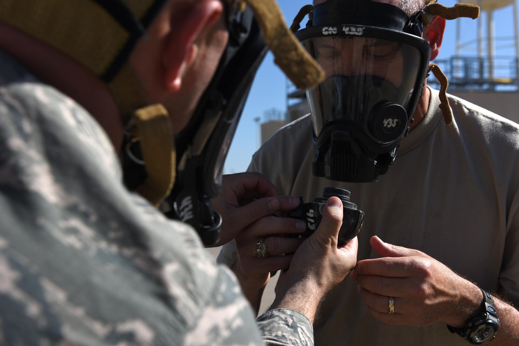 U.S. Air Force Col. Michael Downs, 17th Training Wing Commander, connects a mask to an air tank for firefighter gear drills during a Fire Marshall Training Course at Louis F. Garland Department of Defense Fire Academy on Goodfellow Air Force Base, Texas, Aug. 2, 2016. Downs participated in the course to gain a better understanding of what students in training go through and to meet civil engineer squadron commanders participating in the course. (U.S. Air Force photo by Airman 1st Class Caelynn Ferguson/Released)
