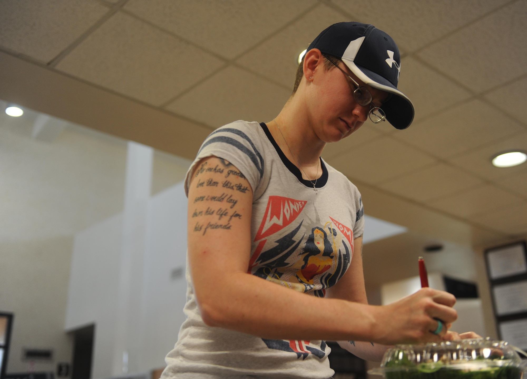 U.S. Air Force Airman 1st Class Michelle Jones, 7th Component Maintenance Squadron egress systems specialist, writes down her contact information on the back of her receipt at the Longhorn Dining Facility July 20, 2016, at Dyess Air Force Base, Texas. For Airmen using their meal card to purchase food, they must request a receipt to enter in the monthly drawing. (U.S. Air Force photo by Airman 1st Class Rebecca Van Syoc)
