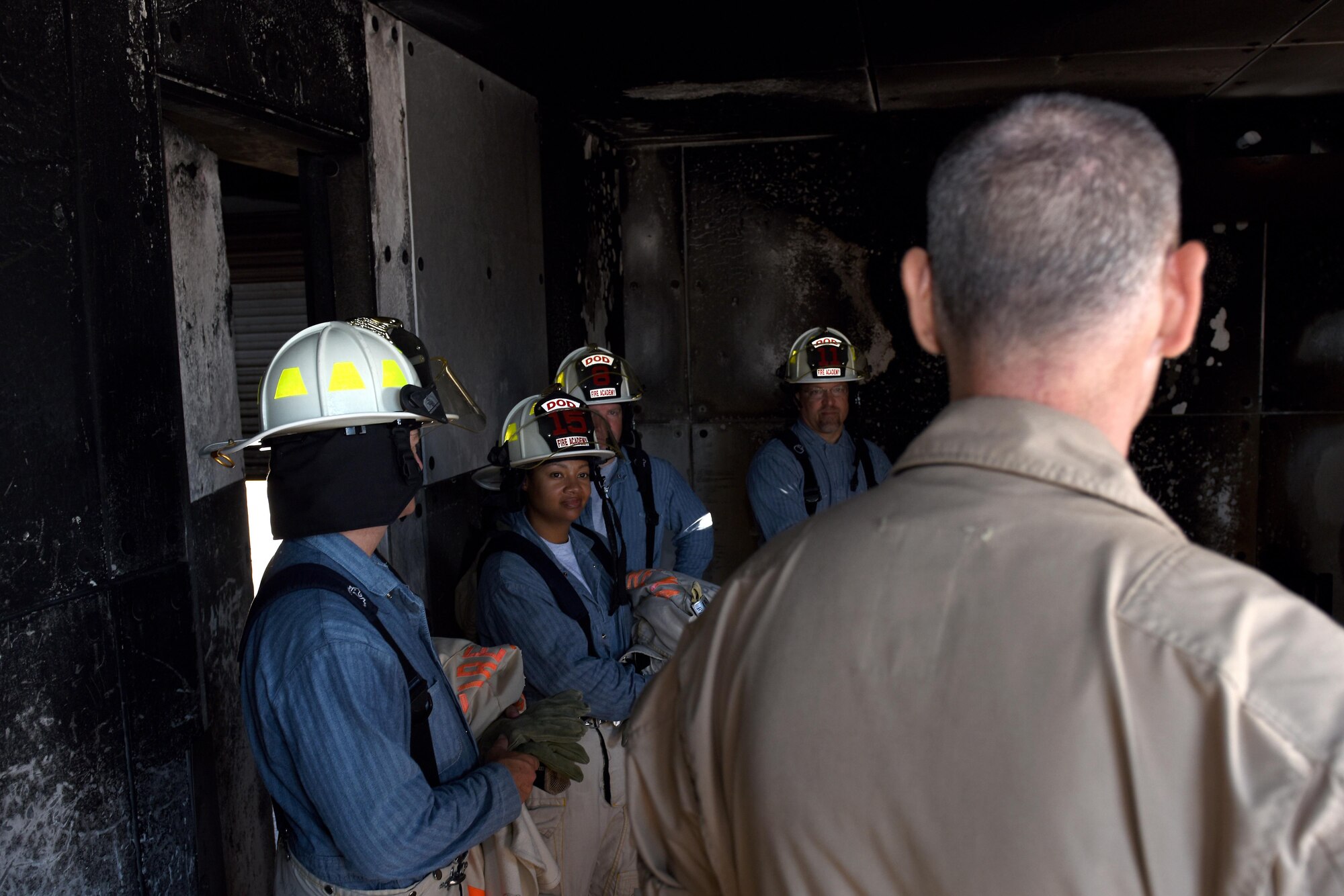 Participants tour fire training buildings during the Fire Marshall course at the Louis F. Garland Department of Defense Fire Academy on Goodfellow Air Force Base, Texas, Aug. 3, 2016. The participants included civil engineer squadron commanders and government emergency services representatives from all over the nation. (U.S. Air Force photo by Airman 1st Class Caelynn Ferguson/Released)