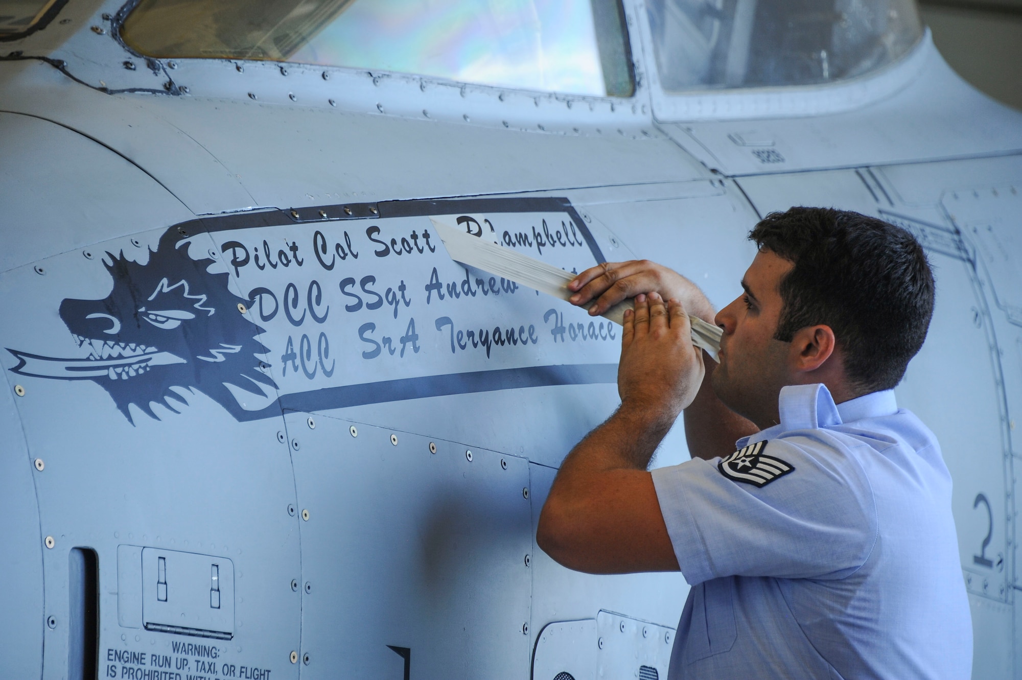 U.S. Air Force Staff Sgt. Andrew, 355th Aircraft Maintenance Squadron A-10 crew chief, unveils the new pilot name of Lightning 1, the A-10C Thunderbolt II reserved for the 355th Fighter Wing commander, during a change of command ceremony at Davis-Monthan Air Force Base, Ariz., Aug. 5, 2016. Col. Scott Campbell assumed command of the 355th FW from Col. James Meger. (U.S. Air Force photo by Airman 1st Class Mya M. Crosby)