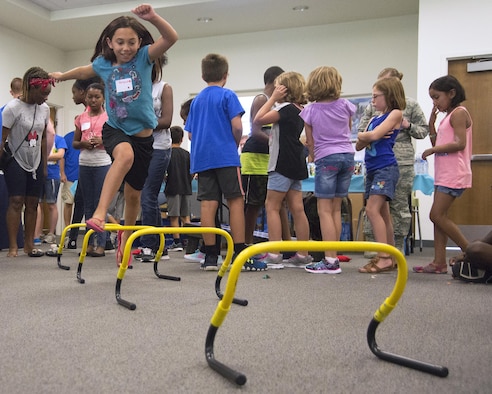 Regan Abbott, 10, races over hurdles during the Stop Bullying, Give Peace a Chance, anti-bullying event, Aug. 2, 2016, in the Religious Education Facility at Wright-Patterson Air Force Base, Ohio. The event was put together by the WBAFB School Liaison Officer in response to an increase in the reports of bullying at the end of last school year. Abbott lives with her father Capt. Scott Abbott, 35th Surgical Operations Squadron, in Misawa Air Base, Japan. (U.S. Air Force photo/R.J. Oriez)