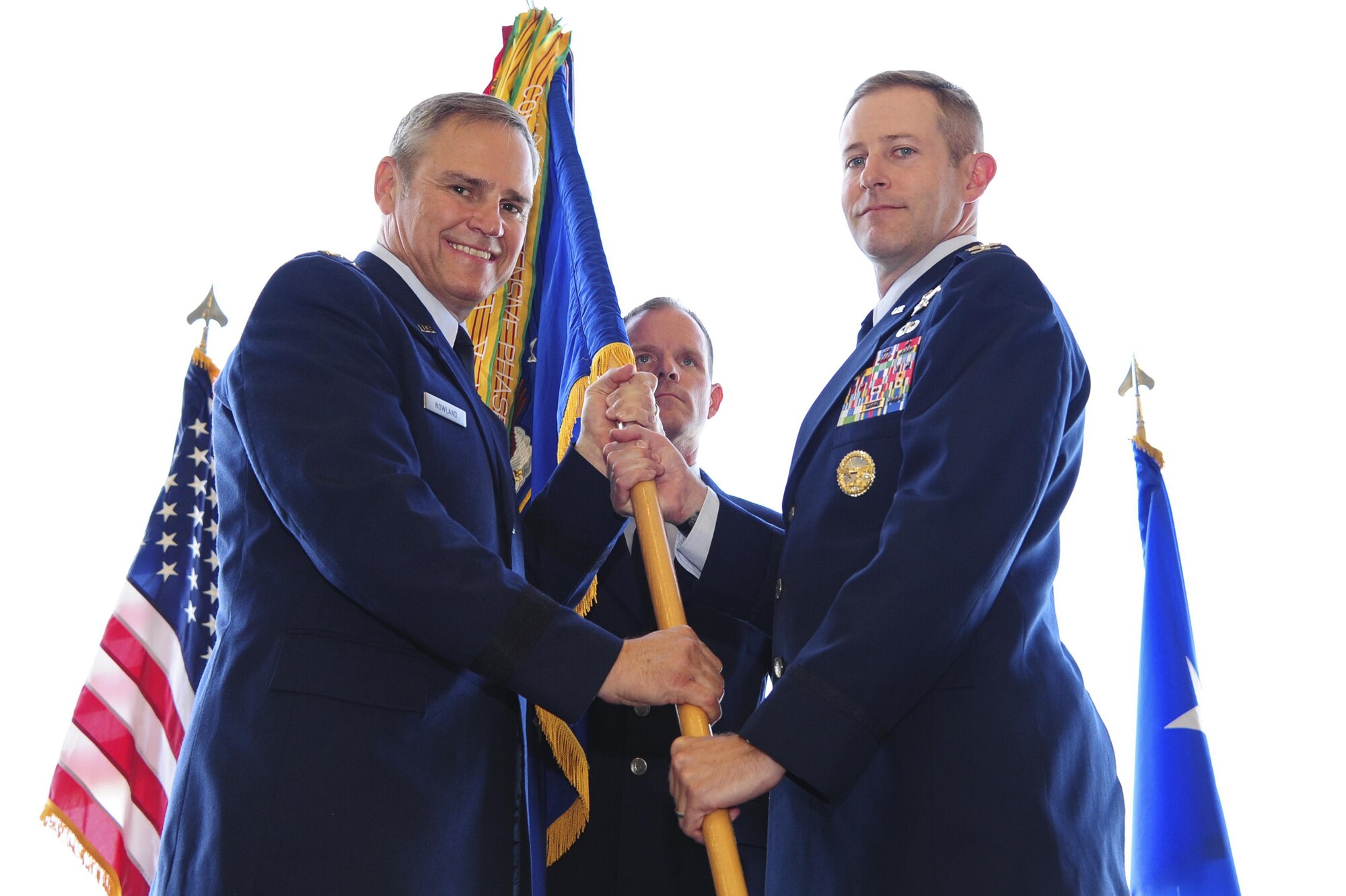 U.S. Air Force Lt. Gen. Chris Nowland, Twelfth Air Force (Air Forces Southern) commander, passes the 355th Fighter Wing guidon to Col. Scott Campbell during the unit’s change of command ceremony at Davis-Monthan Air Force Base, Ariz., Aug. 5, 2016. Before assuming command of the 355th FW, Campbell served as the senior policy advisor to the Deputy Assistant Secretary of Defense for Afghanistan, Pakistan and Central Asia. (U.S. Air Force photo by Senior Airman Chris Drzazgowski)