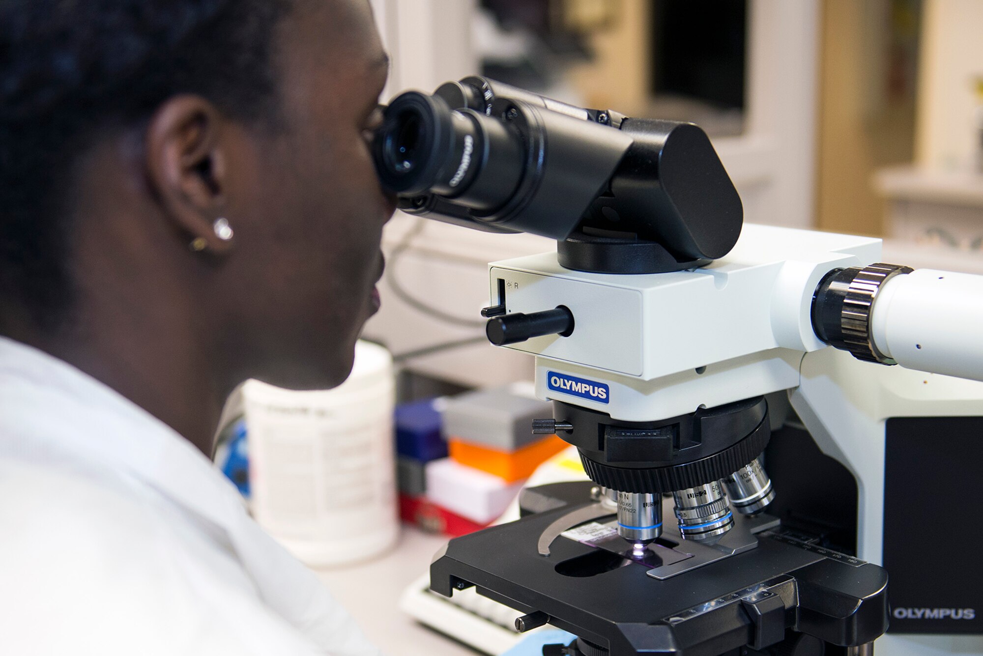 U.S. Air Force Staff Sgt. Brittany Marin, 23d Medical Support Squadron medical laboratory technician, examines a blood smear slide through a microscope, Aug. 4, 2016, at Moody Air Force Base, Ga. The lab uses machinery and equipment to examine specimens that can’t be seen by the human eye to perform analysis on all types of bodily fluids. (U.S. Air Force photo by Airman 1st Class Greg Nash)