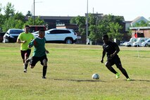 An Airman from the 91st Missile Security Forces Squadron dribbles a soccer ball during the intramural soccer league at Minot Air Force Base, N.D., Aug. 1, 2016. The league kicked off with the 5th SFS facing the 91st MSFS for a chance at winning the Commander’s Cup trophy. (U.S. Air Force photo/Senior Airman Kristoffer Kaubisch)
