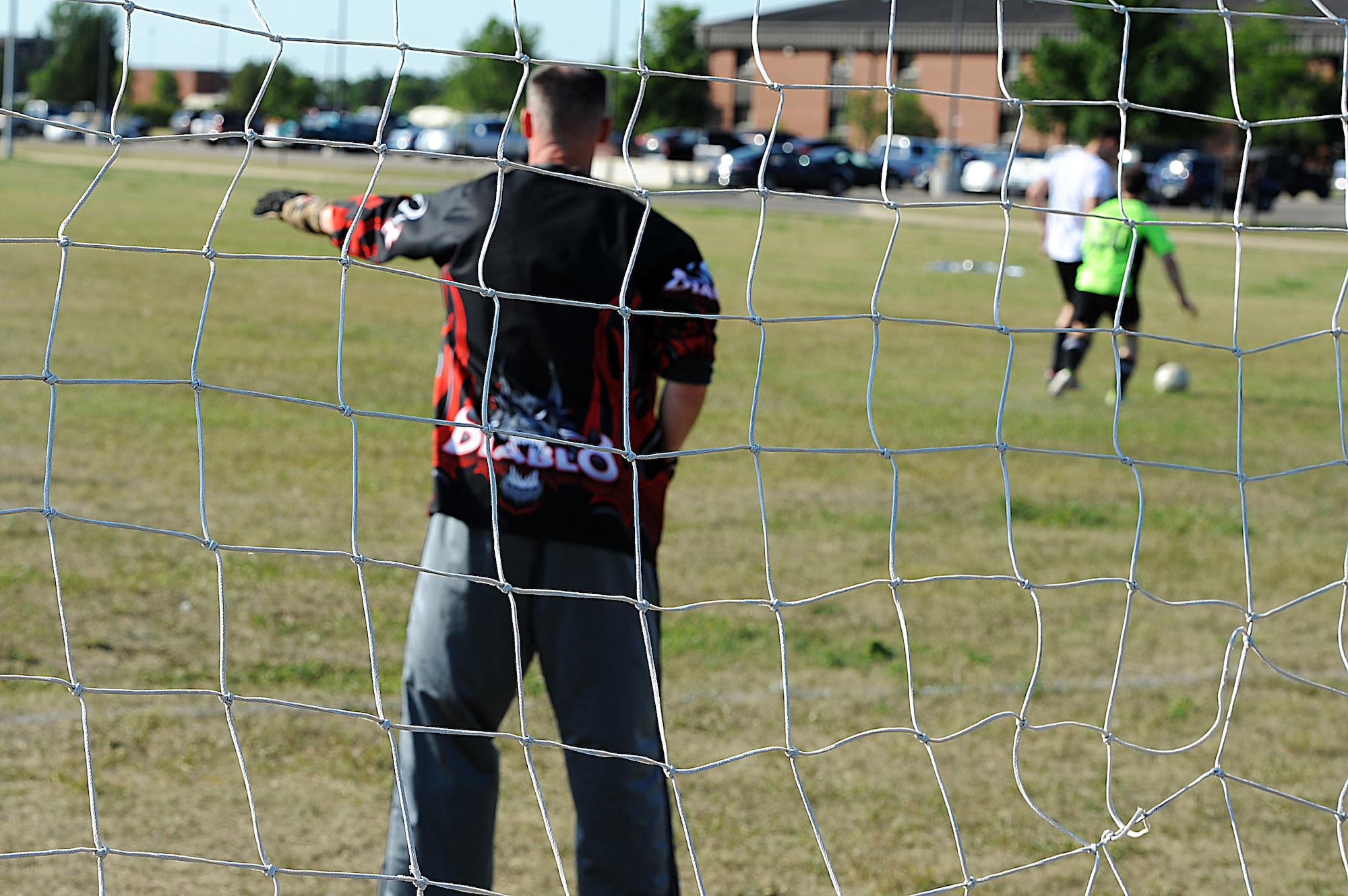 An Airman from the 5th Security Forces Squadron defends the goal during an intramural soccer game at Minot Air Force Base, N.D., Aug. 1, 2016. After an hour of battling in the heat, the game ended in a tie with a final score of 2-2.  (U.S. Air Force photo/Senior Airman Kristoffer Kaubisch)