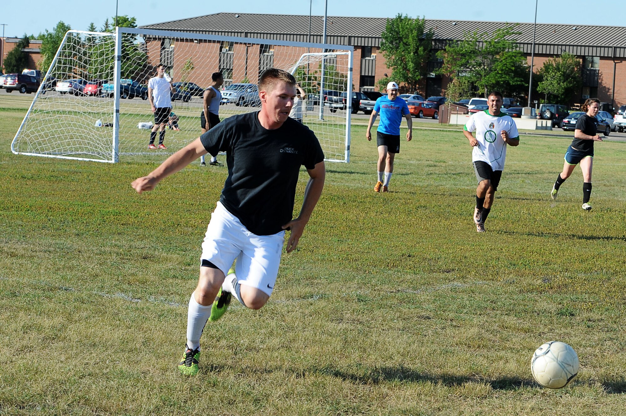 An Airman from the 91st Missile Security Forces Squadron dribbles the ball during an intramural soccer game at Minot Air Force Base, N.D., Aug. 1, 2016. Different squadrons from Minot AFB compete in the league to earn points towards the Commander’s Cup trophy. (U.S. Air Force photo/Senior Airman Kristoffer Kaubisch)