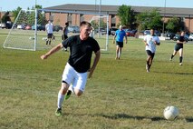 An Airman from the 91st Missile Security Forces Squadron dribbles the ball during an intramural soccer game at Minot Air Force Base, N.D., Aug. 1, 2016. Different squadrons from Minot AFB compete in the league to earn points towards the Commander’s Cup trophy. (U.S. Air Force photo/Senior Airman Kristoffer Kaubisch)