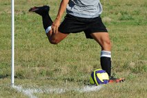 An Airman from the 91st Missile Security Forces Squadron takes a corner kick during an intramural soccer game at Minot Air Force Base, N.D., Aug. 1, 2016. Different squadrons on base compete in the league to earn points towards the Commander’s Cup trophy. (U.S. Air Force photo/Senior Airman Kristoffer Kaubisch)