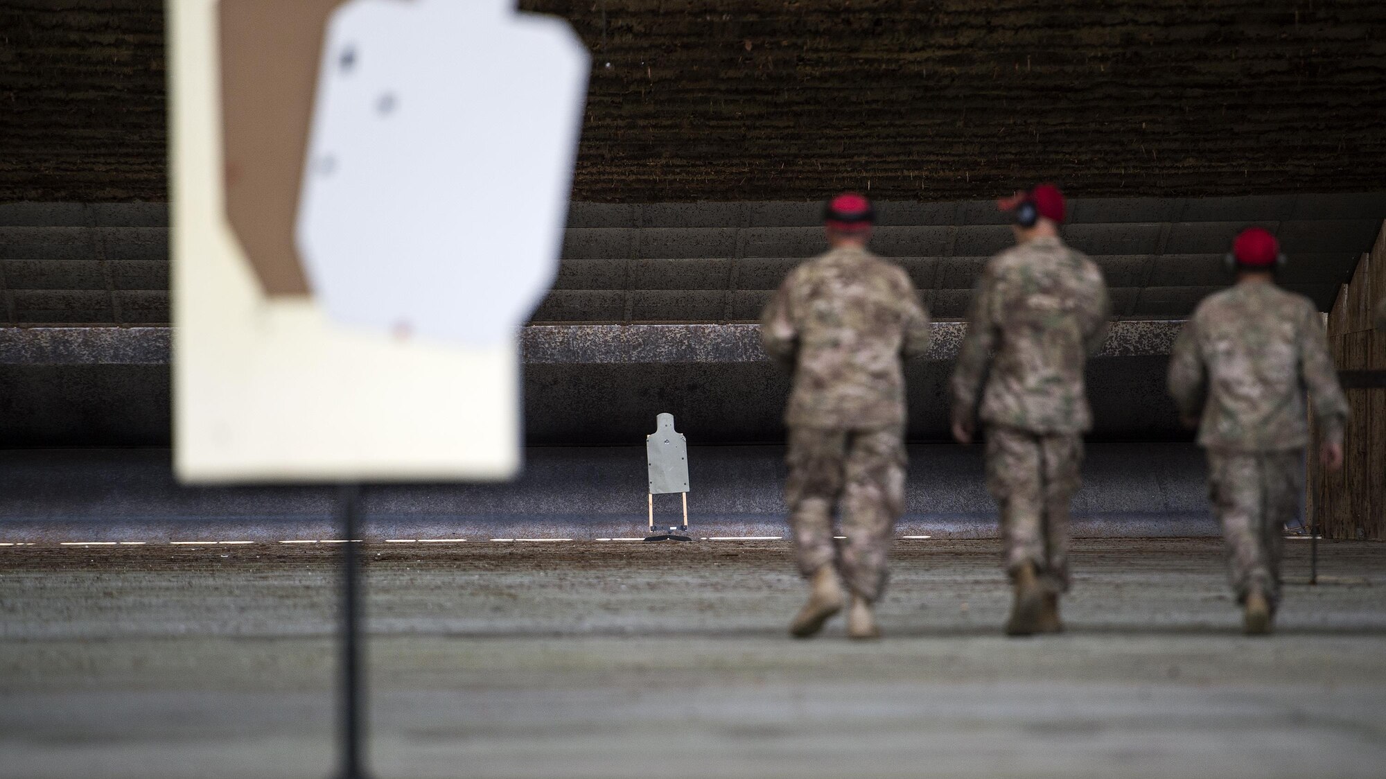 Moody’s Combat Arms Training and Maintenance instructors walk downrange to retrieve targets after a fire-challenge course, Aug. 4, 2016, at Moody Air Force Base, Ga. U.S. Air Force Col. Jeffery Valenzia, 93d Air Ground Operations Wing commander, challenged three other 93d AGOW leaders to see who could accurately shoot a coin on a target more than 75 feet away. (U.S. Air Force photo by Airman 1st Class Janiqua P. Robinson)