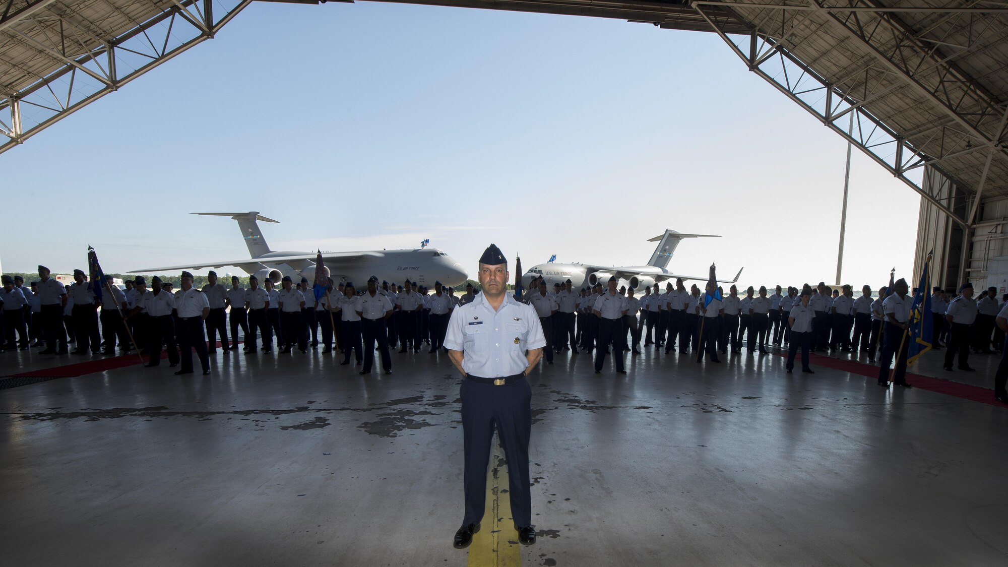 Col. Doug Hall, 436th Operations Group commander, stands at parade rest in front of a formation of 436th Airlift Wing Airmen during the 436th AW change of command ceremony Aug. 5, 2016, inside Hangar 706, on Dover Air Force Base, Del. Hall acted as commander of troops for the ceremony. (U.S. Air Force photo/Senior Airman Zachary Cacicia)