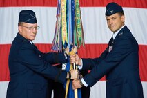Col. Ethan Griffin, right, accepts the wing colors from Brig. Gen. Patrick Mordente, 18th Air Force vice commander, left, Aug. 5, 2016, inside Hangar 706, on Dover Air Force Base, Del. Griffin assumed command of the 436th Airlift Wing during a change of command ceremony and became 436th AW’s 33rd commander. (U.S. Air Force photo/Roland Balik)