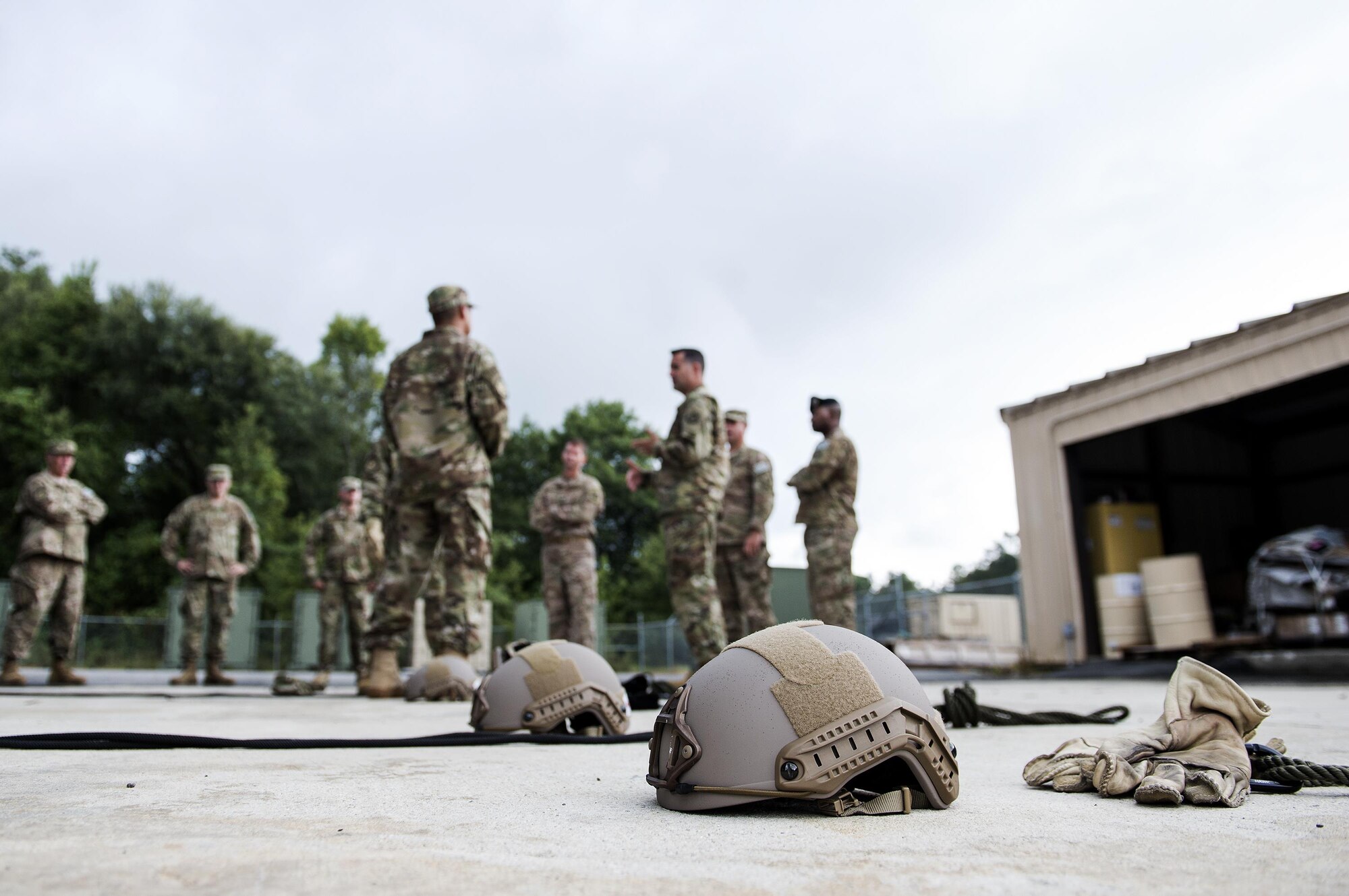 Helmets sit on the ground while members of the 820th Combat Operations Squadron give a safety briefing to the 93d Air Ground Operations Wing leadership during an immersion, Aug. 5, 2016, at Moody Air Force Base, Ga. The rappel tower at Moody is used to train U.S. Airmen for Air Assault School and to keep their status up-to-date after they've completed their training. (U.S. Air Force photo by Airman 1st Class Janiqua P. Robinson)