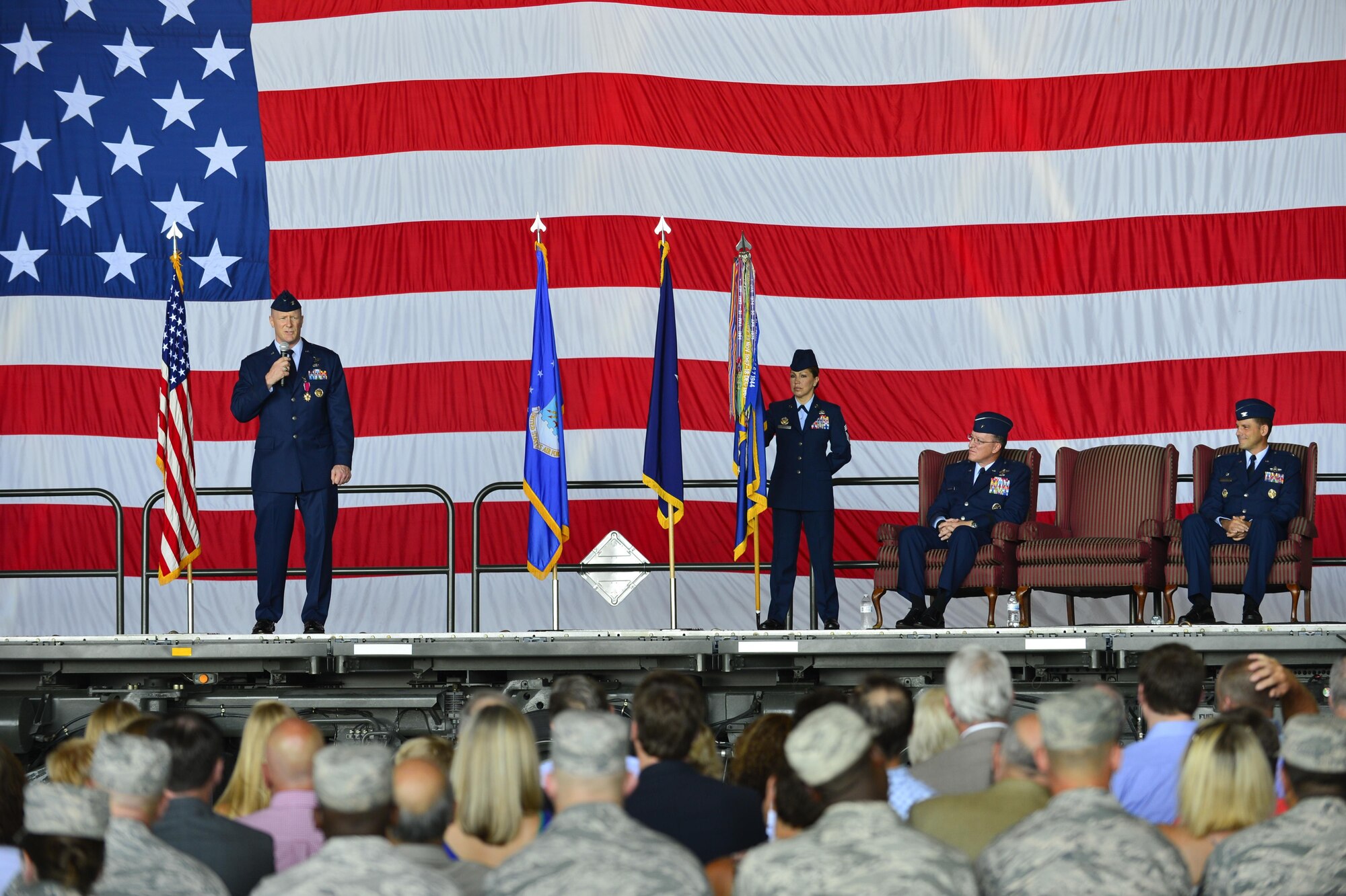 Col. Michael Grismer, outgoing 436th Airlift Wing commander, speaks during the 436th AW Change of Command ceremony Aug. 5, 2016, inside Hangar 706, on Dover Air Force Base, Del. Grismer will retire from the Air Force after 26 years of service. (U.S. Air Force photo/Senior Airman William Johnson)
