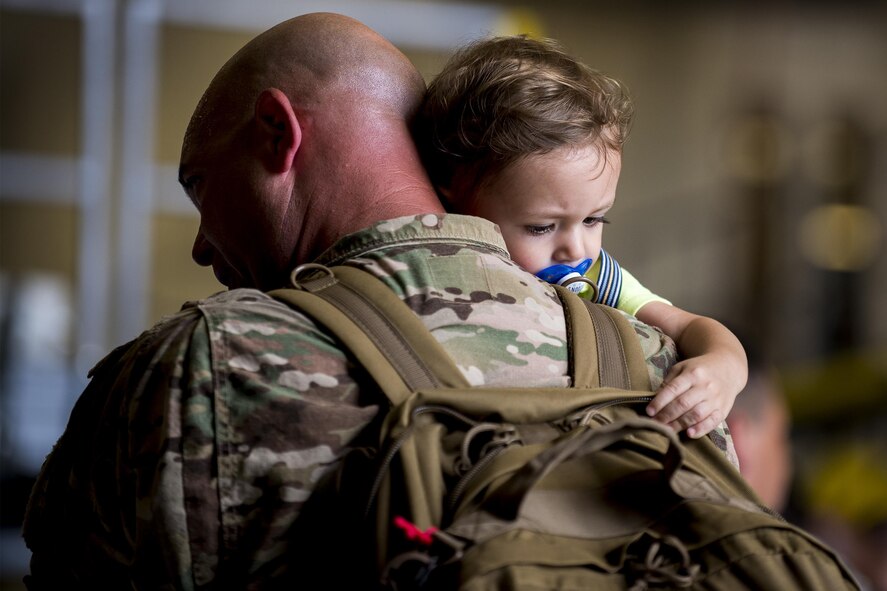 U.S. Air Force Master. Sgt. Bryan Greeley, 723d Aircraft Maintenance Squadron production superintendent, holds his son, Nicholas, after returning from a deployment, Aug. 5, 2016, at Moody Air Force Base, Ga. While deployed, the 723d AMXS was responsible for maintaining the mission-ready status of HH-60G Pave Hawks and HC-130J Combat King IIs. (U.S. Air Force photo by Airman Daniel Snider)