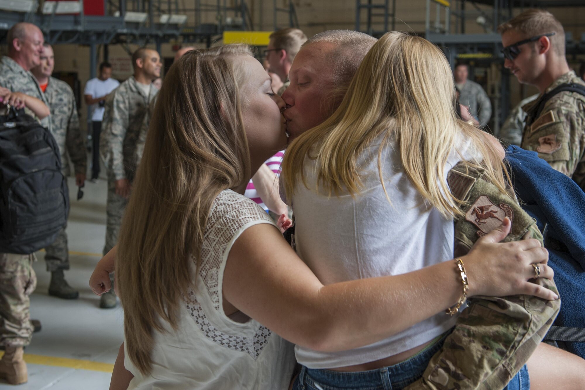 U.S. Air Force Staff Sgt. Michael Bortle, 23d Equipment Maintenance Squadron aerospace ground equipment craftsman, kisses his wife Amanda after returning from a deployment, Aug. 5, 2016, at Moody Air Force Base, Ga.  Approximately 50 Airmen returned from a four-month deployment supporting operations in the horn of Africa. (U.S. Air Force photo by Airman Daniel Snider)
