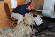 Jeremy Smith, 5th Security Forces Squadron Combat Arms instructor, shows a member of the 5th Security Forces Squadron which target to fire at during M240B machine gun training at Minot Air Force Base, N.D., Aug. 4, 2016. Smith trains Security Forces Airmen daily on the proper assembly, firing and cleaning of all weapons used at Minot AFB. (U.S. Air Force photo/ Senior Airman Kristoffer Kaubisch)