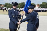 U.S. Air Force Lt. Gen. Darryl Roberson, commander of Air Education and Training Command, passes the guidon to Brig. Gen. Heather Pringle during the 502nd Air Base Wing and Joint Base San Antonio change of command ceremony at JBSA-Fort Sam Houston's MacArthur Parade Field Aug. 5, 2016. The 502nd ABW and JBSA provide installation support for 266 mission partners across 11 JBSA operating locations. 