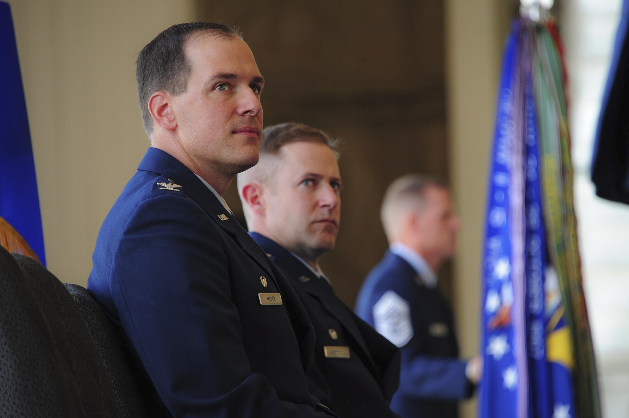 U.S. Air Force Col. James Meger, outgoing 355th Fighter Wing commander, and Col. Scott Campbell, incoming 355th FW commander, listen to remarks during a change of command ceremony at Davis-Monthan Air Force Base, Ariz., Aug. 5, 2016. Meger relinquished his command of the 355th FW bringing a close to his 24-year-long career in the USAF. (U.S. Air Force photo by Senior Airman Chris Drzazgowski) 