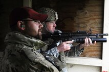Jeremy Smith, Combat Arms instructor, looks on as a Security Forces member fires an M-203 grenade launcher  during annual firing for defenders at Minot Air Force Base, N.D., June 15, 2016. Prior to firing, the defenders learned how to break down the M-203 and clean it. To carry the weapon, defenders must qualify annually. (U.S. Air Force photo/Senior Airman Kristoffer Kaubisch)