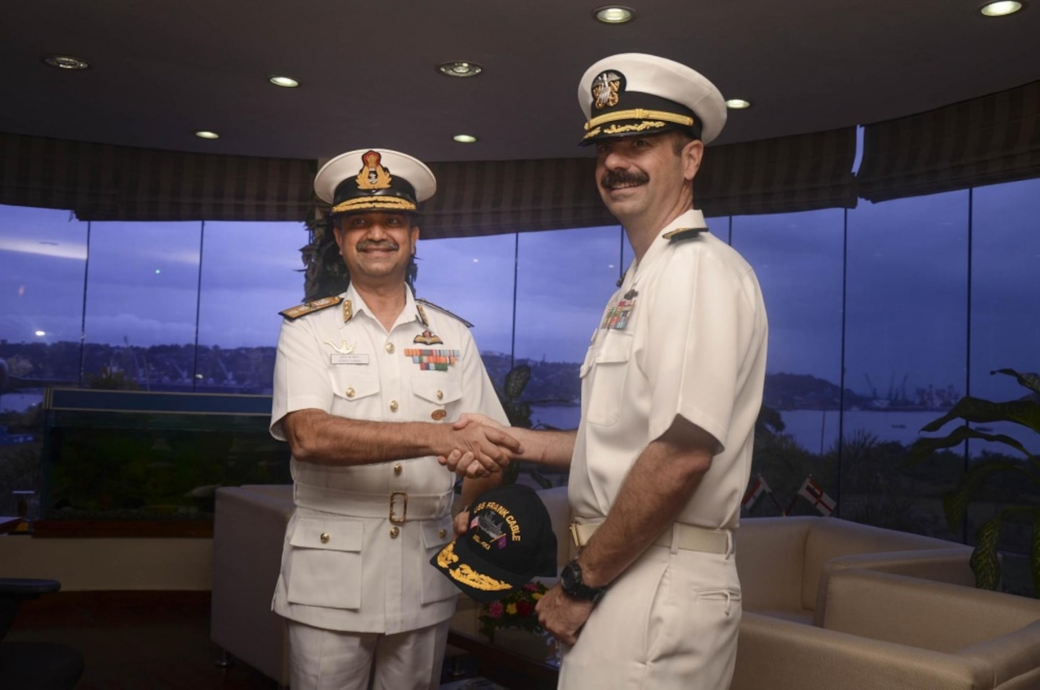 Capt. Drew St. John, commanding officer of the submarine tender USS Frank Cable (AS 40), presents Rear Adm. Puneet Kumar Bahl, Flag Officer Naval Aviation, Flag Officer Goa Area, with a decorated Navy ball cap for his appreciation for a continuation of positive relations between the U.S. and Indian Navy, July 29. The visit to Goa is aimed at building friendship and goodwill between the U.S. Navy and the People of India. Frank Cable is one of two forward-deployed U.S. naval force submarines and surface vessels in the Indo-Asia-Pacific region.