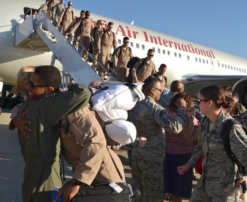 Lt. Col. Kristen Thompson, left, 960th Airborne Air Control Squadron commander, greets a long line of Airmen returning to Tinker from deployment to Southwest Asia.