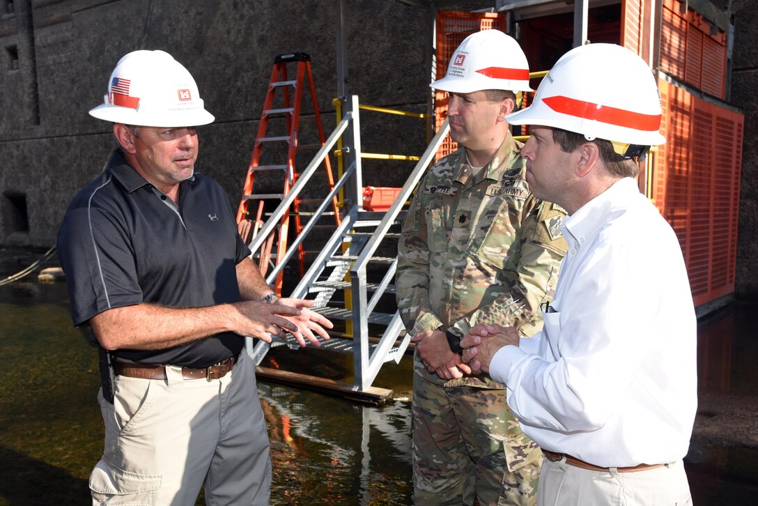 Greg Cox (Left), chief of maintenance for the Corps of Engineers maintenance team at Chickamauga Lock in Chattanooga, Tenn., provides an update about the ongoing inspection and repairs at the dewatered lock to Congressman Chuck Fleischmann, Tennessee District 3, and Lt. Col. Stephen Murphy, U.S. Army Corps of Engineers Nashville District commander, inside the chamber Aug. 3, 2016.