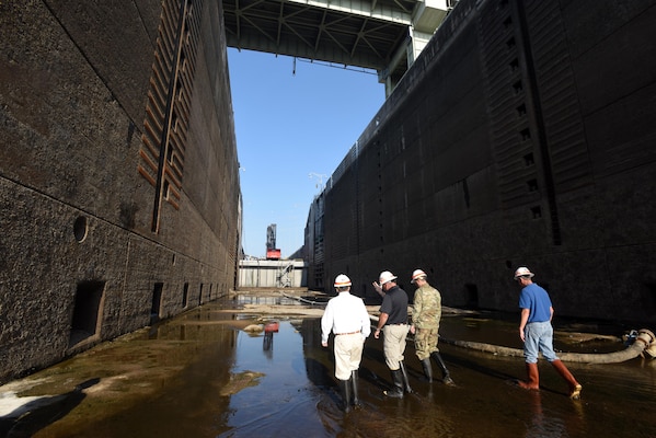 Congressman Chuck Fleischmann (Left), Tennessee District 3, walks through the grit, grime and pools of water inside the dewatered Chickamauga Lock Aug. 3, 2016 during a visit to see firsthand the condition of the lock while U.S. Army Corps of Engineers Nashville District personnel repair the components, valves and gates that deteriorate under the 11 million gallons of water the lock holds.