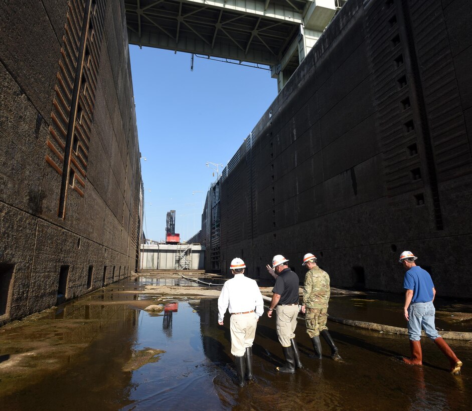 Congressman Chuck Fleischmann (Left), Tennessee District 3, walks through the grit, grime and pools of water inside the dewatered Chickamauga Lock Aug. 3, 2016 during a visit to see firsthand the condition of the lock while U.S. Army Corps of Engineers Nashville District personnel repair the components, valves and gates that deteriorate under the 11 million gallons of water the lock holds.