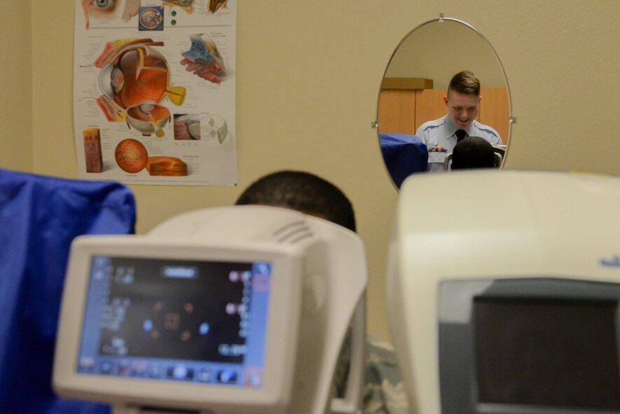 Airman 1st Class Jacob Turner, an optometry technician assigned to the 5th Medical Operations Squadron, performs an auto refraction exam during a screening at Minot Air Force Base, N.D., Aug. 5, 2016. The auto refraction exam uses the eyes reaction of the clearest image to produce a baseline prescription for the optometrist to finalize the appointment. (U.S. Air Force photo/Airman 1st Class Jessica Weissman)