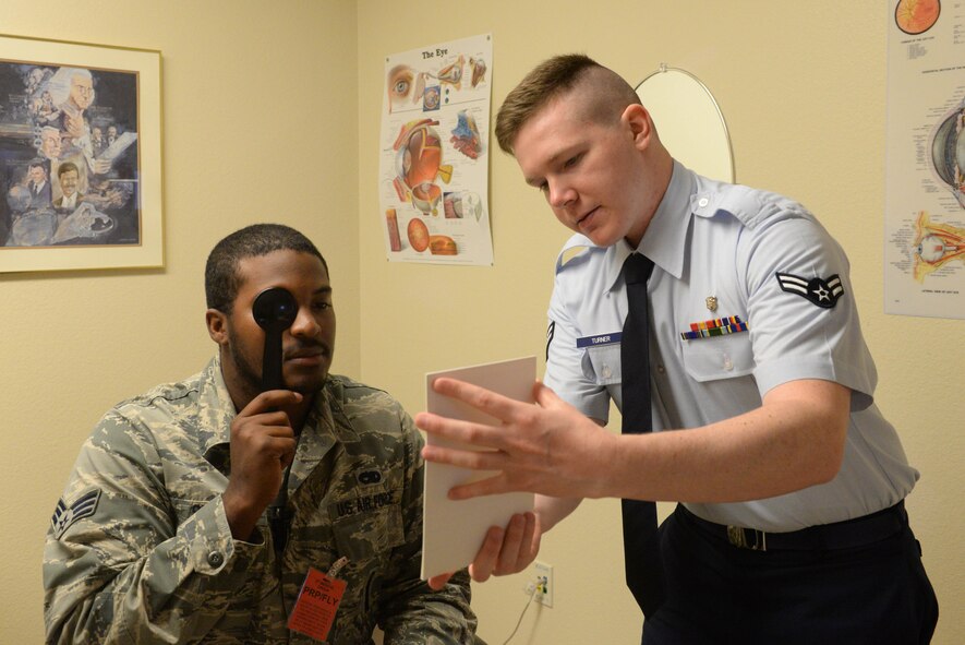 Airman 1st Class Jacob Turner, an optometry technician assigned to the 5th Medical Operations Squadron, holds a Snellen chart to approximate the patient’s distance vision at Minot Air Force Base, N.D., Aug. 5, 2016. Ensuring patients have the proper prescription is important for them to accurately perform their respective jobs. (U.S. Air Force photo/Airman 1st Class Jessica Weissman)