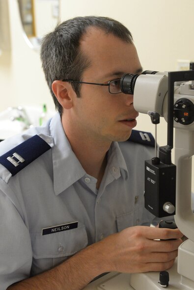 Capt. Makay Neilson, an optometrist assigned to the 5th Medical Operations Squadron, uses a slit lamp at Minot Air Force Base, N.D., Aug. 5, 2016. The slit lamp is a magnification of the inner layer of the eye that looks for defects in a patient’s eye. (U.S. Air Force photo/Airman 1st Class Jessica Weissman)