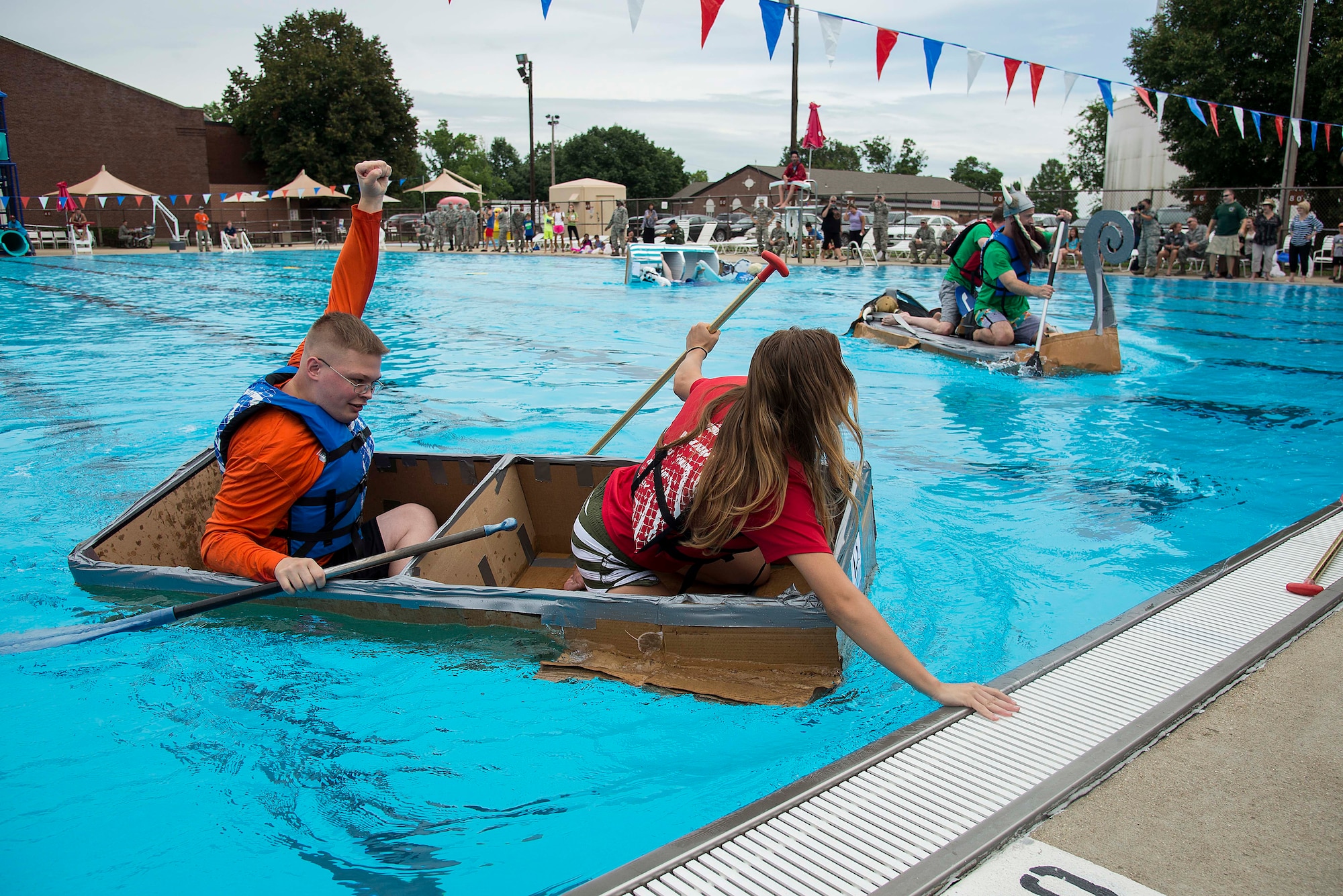 Members of the 375th Medical Operations Squadron team finish the first heat during the annual boat regatta at Scott Air Force Base, Ill., Aug. 5, 2016. The 375th MDOS team won the first heat but sank during the final race. (U.S. Air Force photo by Tech. Sgt. Jonathan Fowler)