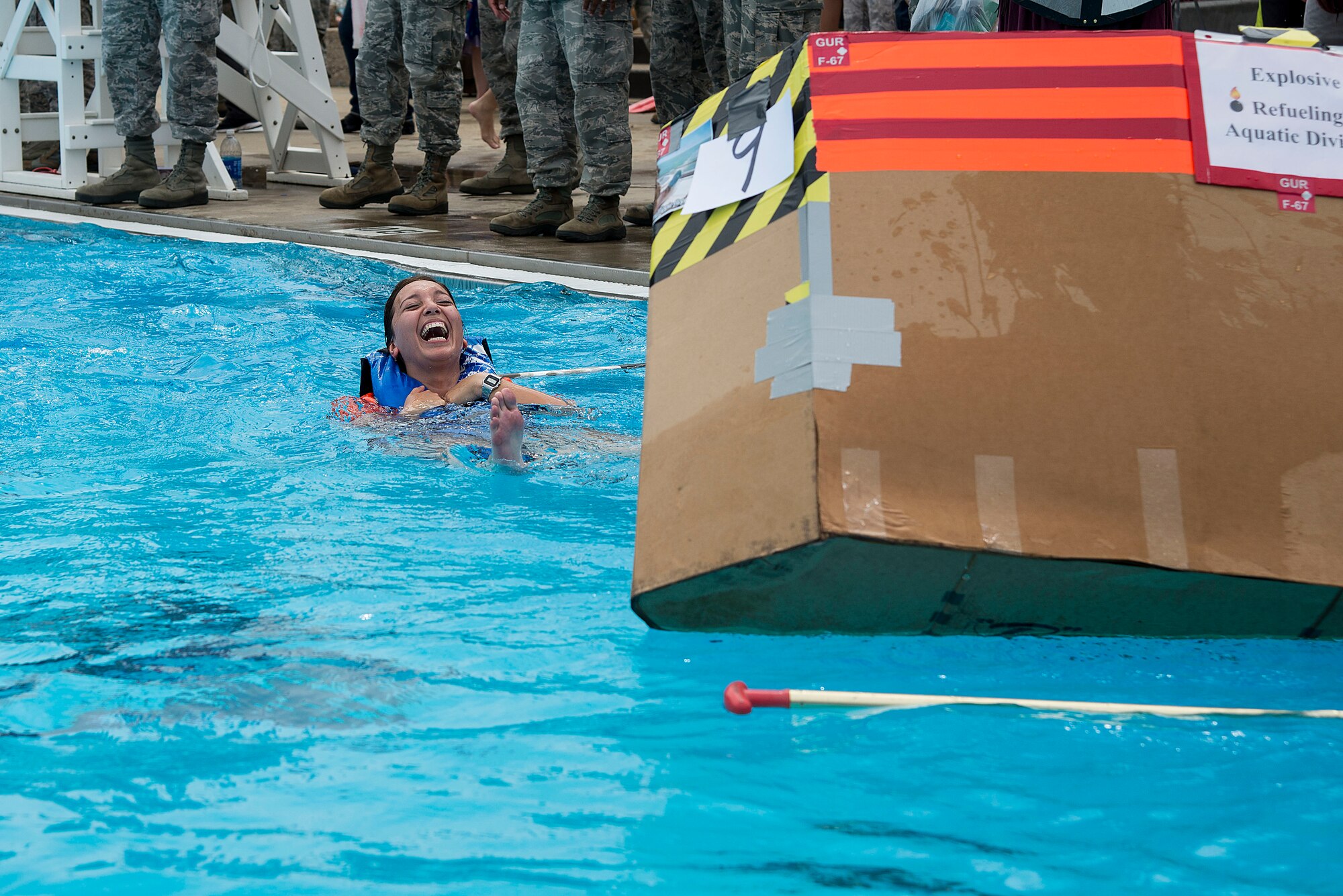 A member of the 375th Logistics Readiness Squadron Petrolium, Oil and Lubricants flight team laughs after falling out of her boat during the annual boat regatta at Scott Air Force Base, Ill., Aug. 5, 2016. Another 375th LRS team ultimately finished first in the boat regatta. (U.S. Air Force photo by Tech. Sgt. Jonathan Fowler)