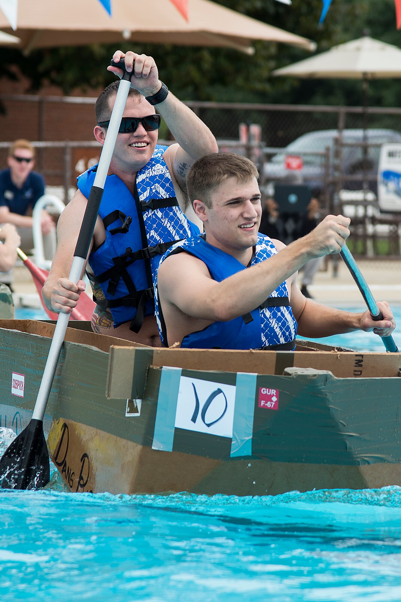 Members of the 375th Logistics Readiness Squadron D flight team compete in the annual boat regatta at Scott Air Force Base, Ill., Aug. 5, 2016. Their team won first place in the regatta, which is held annual at the Scott AFB Pool. (U.S. Air Force photo by Tech. Sgt. Jonathan Fowler)