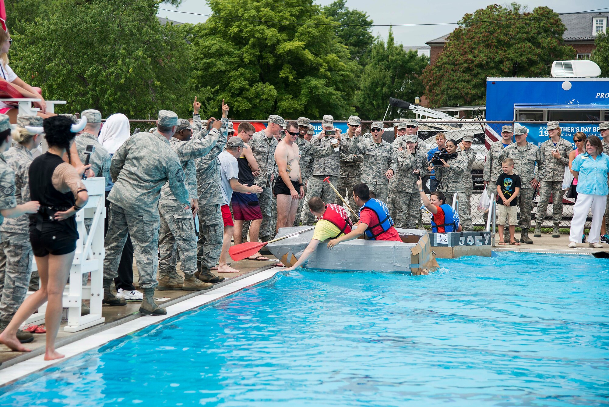 The crowd cheers as two teams finish the third heat of the annual boat regatta at Scott Air Force Base, Ill., Aug. 5, 2016. The event featured 14 teams from a number of organizations around base. (U.S. Air Force photo by Tech. Sgt. Jonathan Fowler)
