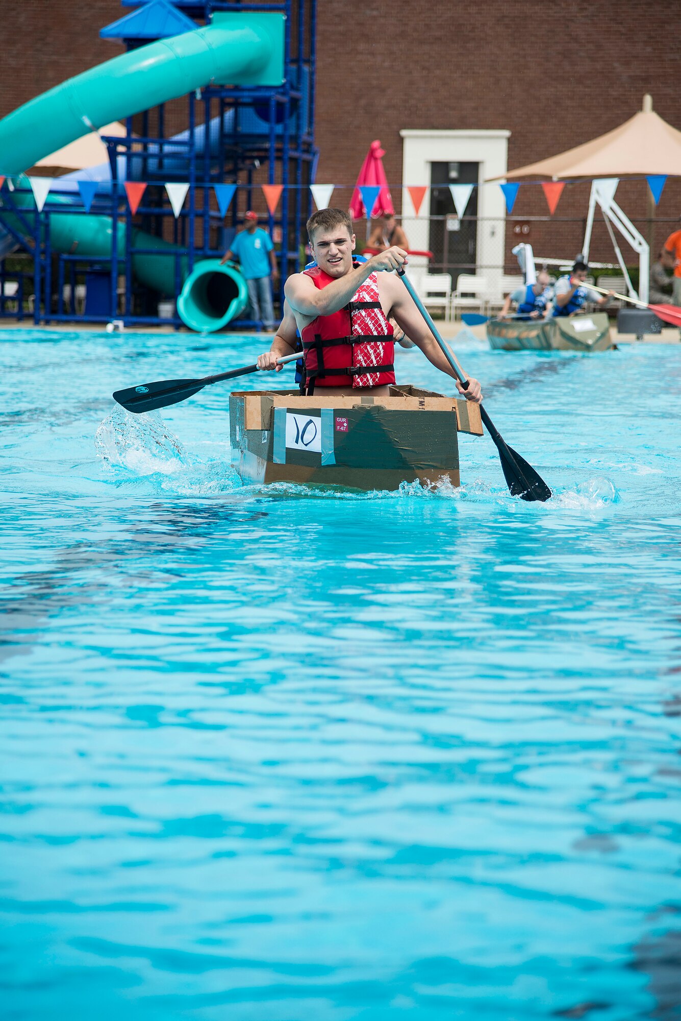 Members of the 375th Logistics Readiness Squadron D flight team compete in the annual boat regatta at Scott Air Force Base, Ill., Aug. 5, 2016. Their team won first place in the regatta, which is held annual at the Scott AFB Pool. (U.S. Air Force photo by Tech. Sgt. Jonathan Fowler)