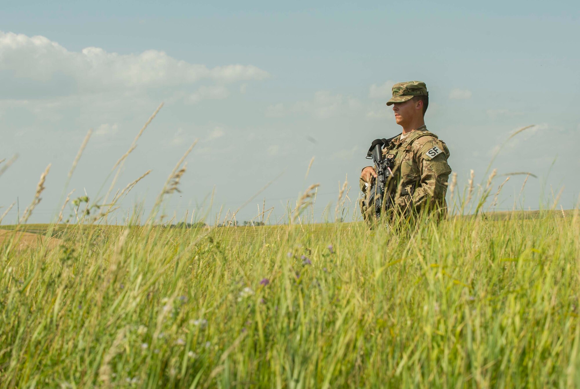 Airman 1st Class Jacob McWilliams, 91st Missile Security Forces Squadron fire team member, does a security sweep around a launch facility in the missile complex, N.D., Aug. 3, 2016. Missile wing defenders trip out to the missile field for four-day periods to provide security for the missile complex. (U.S. Air Force photo/Senior Airman Apryl Hall)
