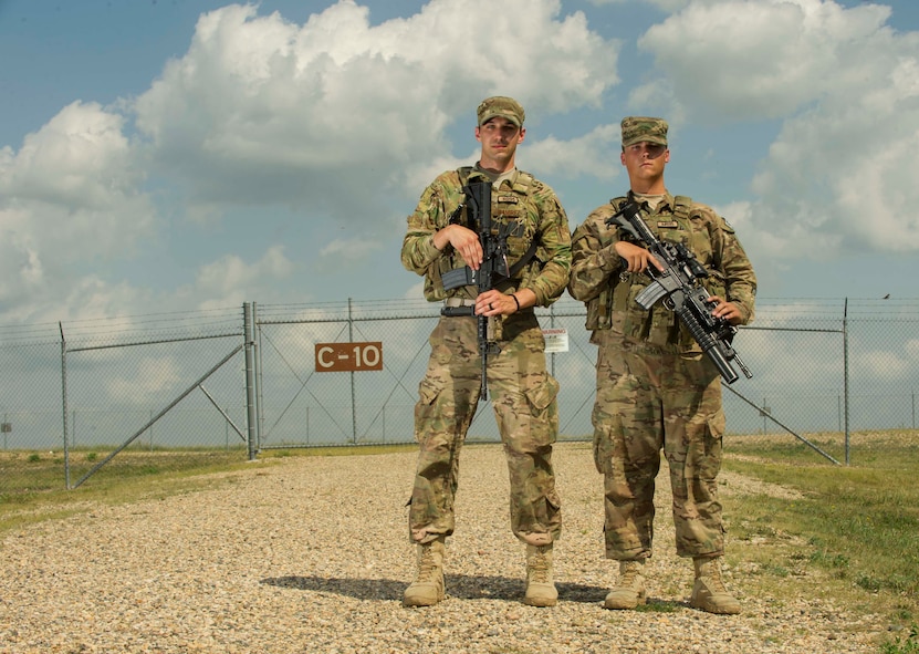 Airman 1st Class Jacob McWilliams and A1C Dalton Ramirez, 91st Missile Security Forces Squadron fire team members, pull security at a launch facility in the missile complex, N.D., Aug. 3, 2016. Missile wing defenders are responsible for providing security at 150 launch facilities and 15 missile alert facilities. (U.S. Air Force photo/Senior Airman Apryl Hall)