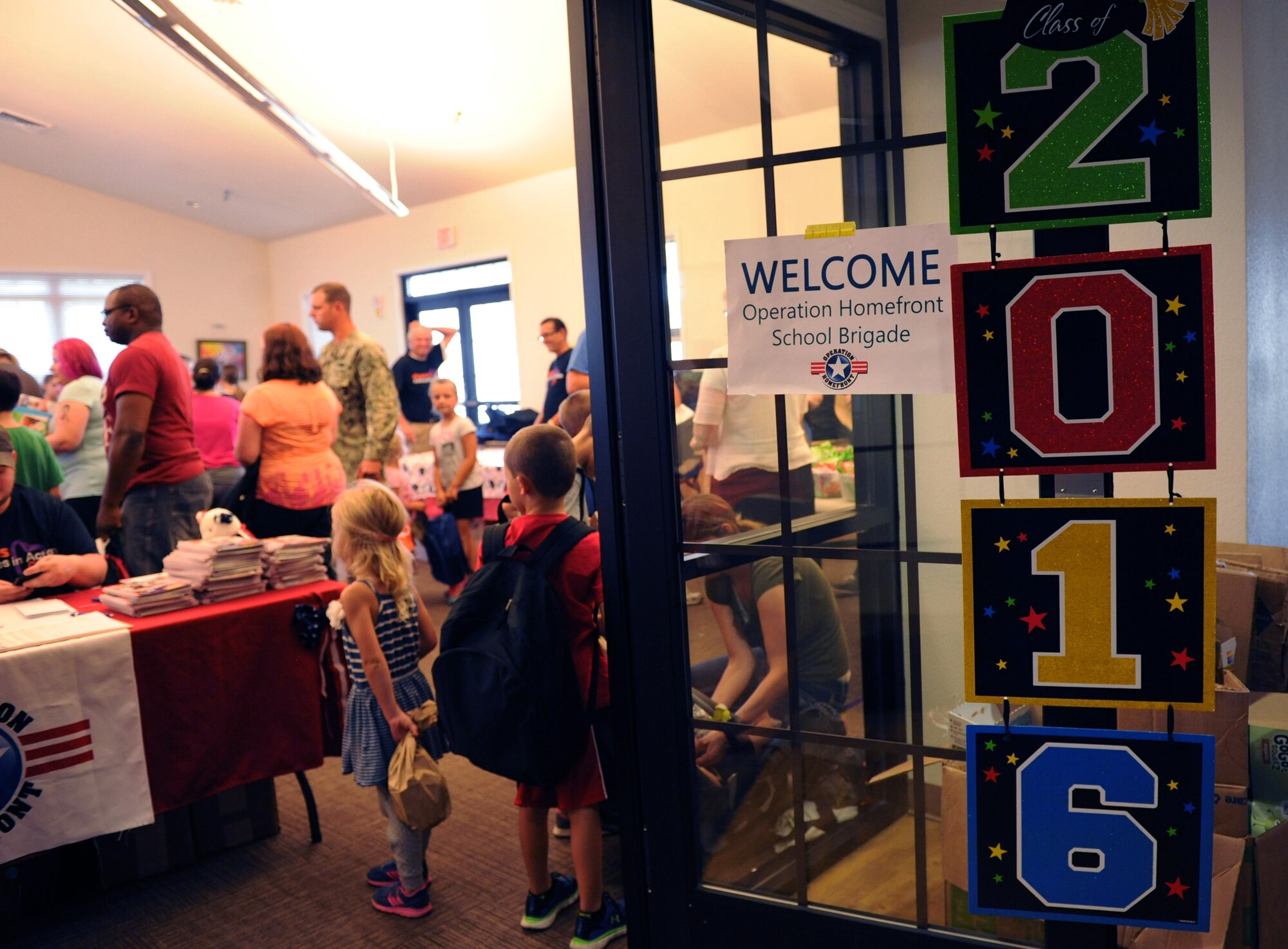 Military families gather at the Bay Ridge Community Center for a back-to-school event sponsored by Operation Homefront July 2, 2016, on Keesler Air Force Base, Miss. The event provided military families with backpacks and school supplies. (U.S. Air Force photo by Kemberly Groue/Released)